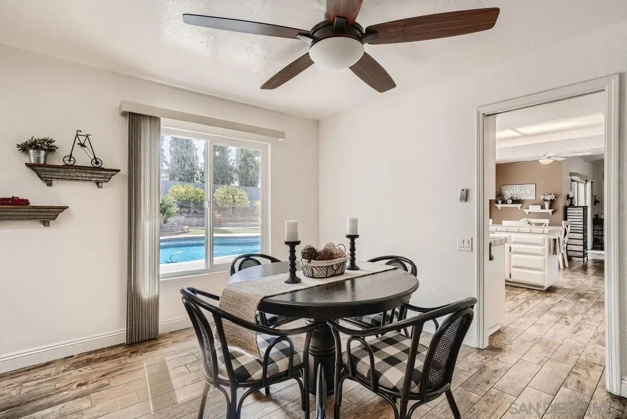 Dining area remodel in San Diego with pool view through large window