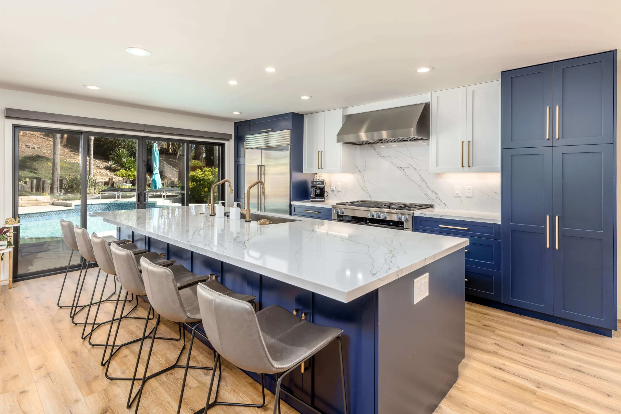 Custom kitchen remodel in San Diego with blue island and marble countertops by Teknik