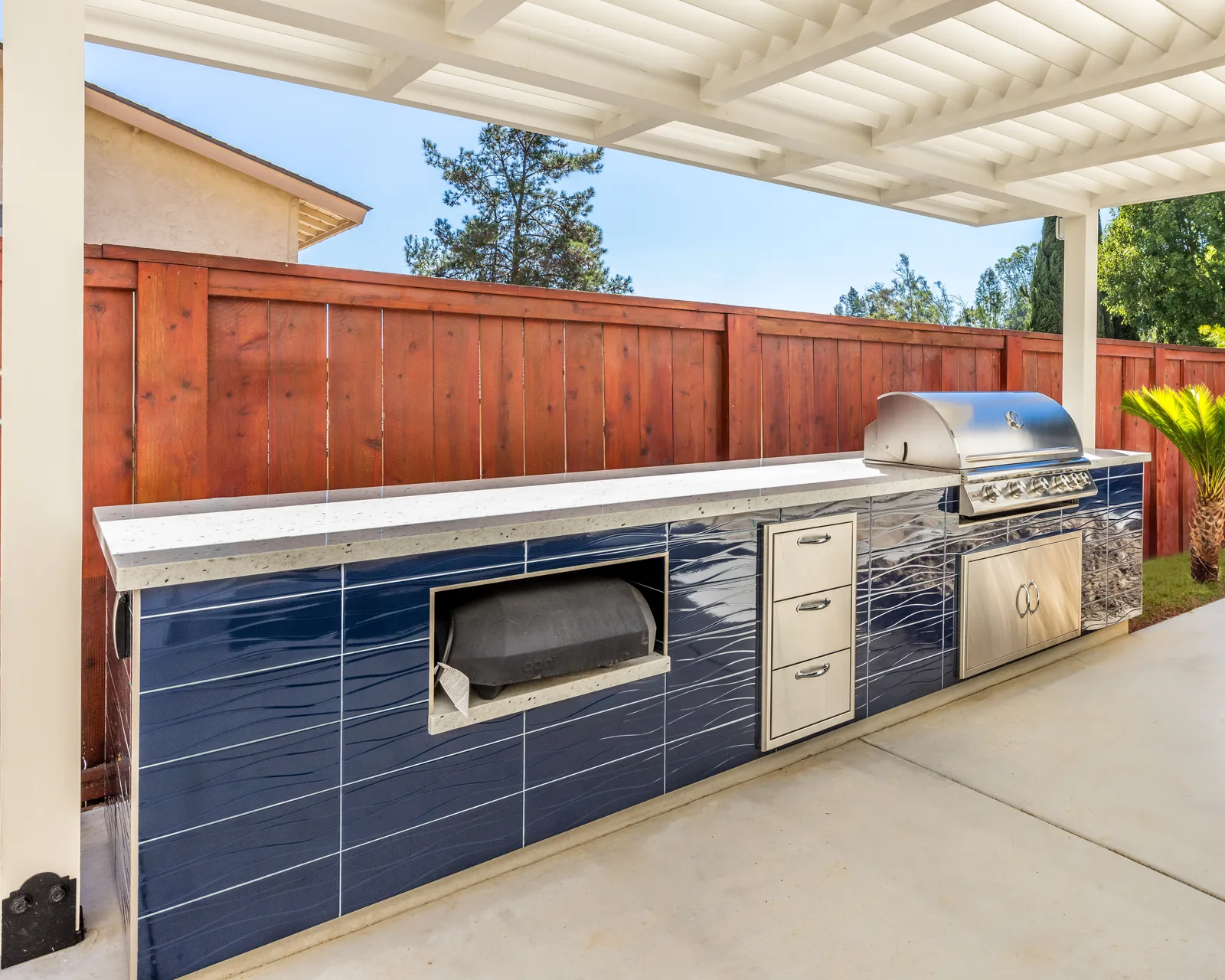 Built-in blue outdoor kitchen and entertaining patio, De Luca remodel