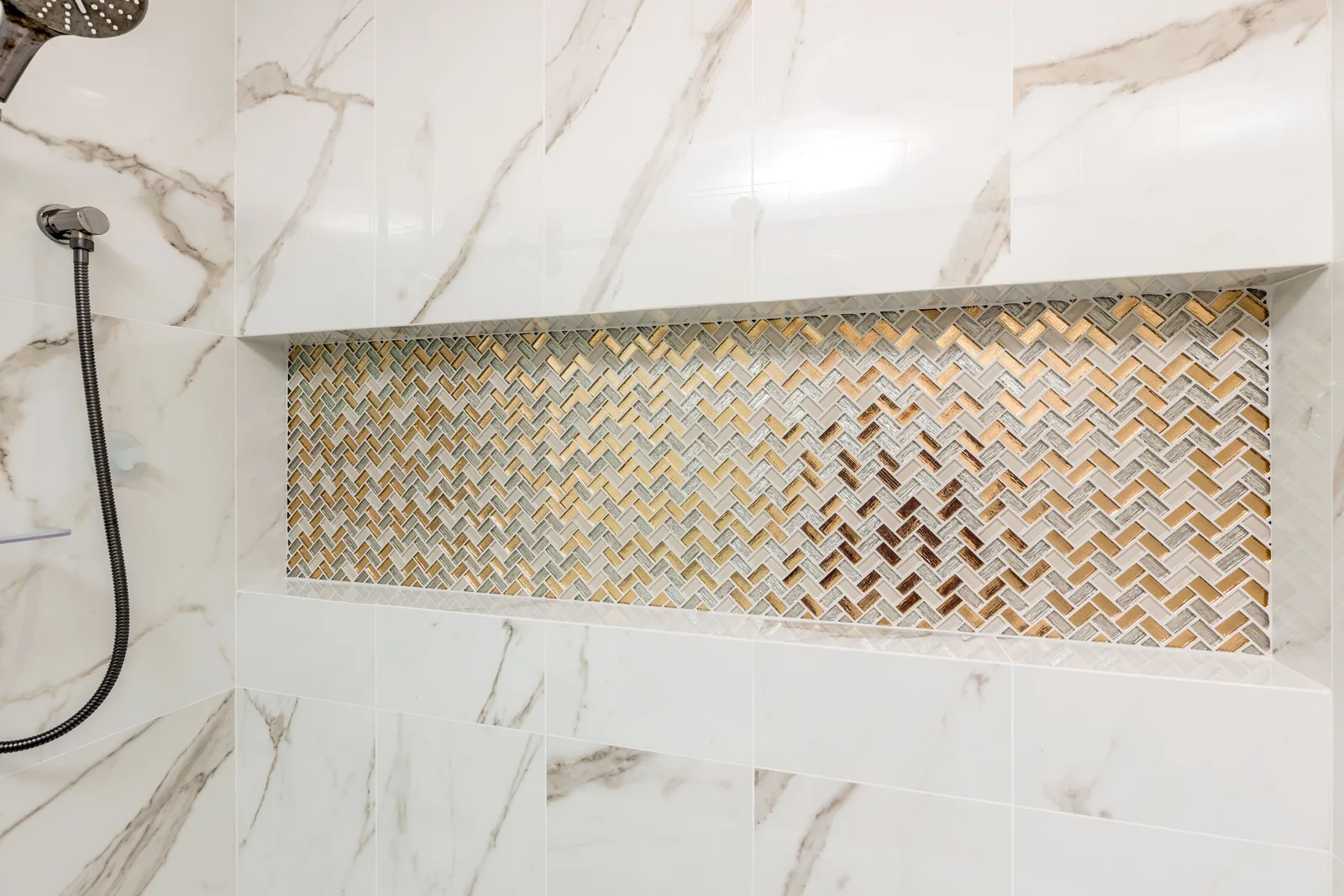 Marble slab shower with herringbone mosaic niche detail, De Luca remodel