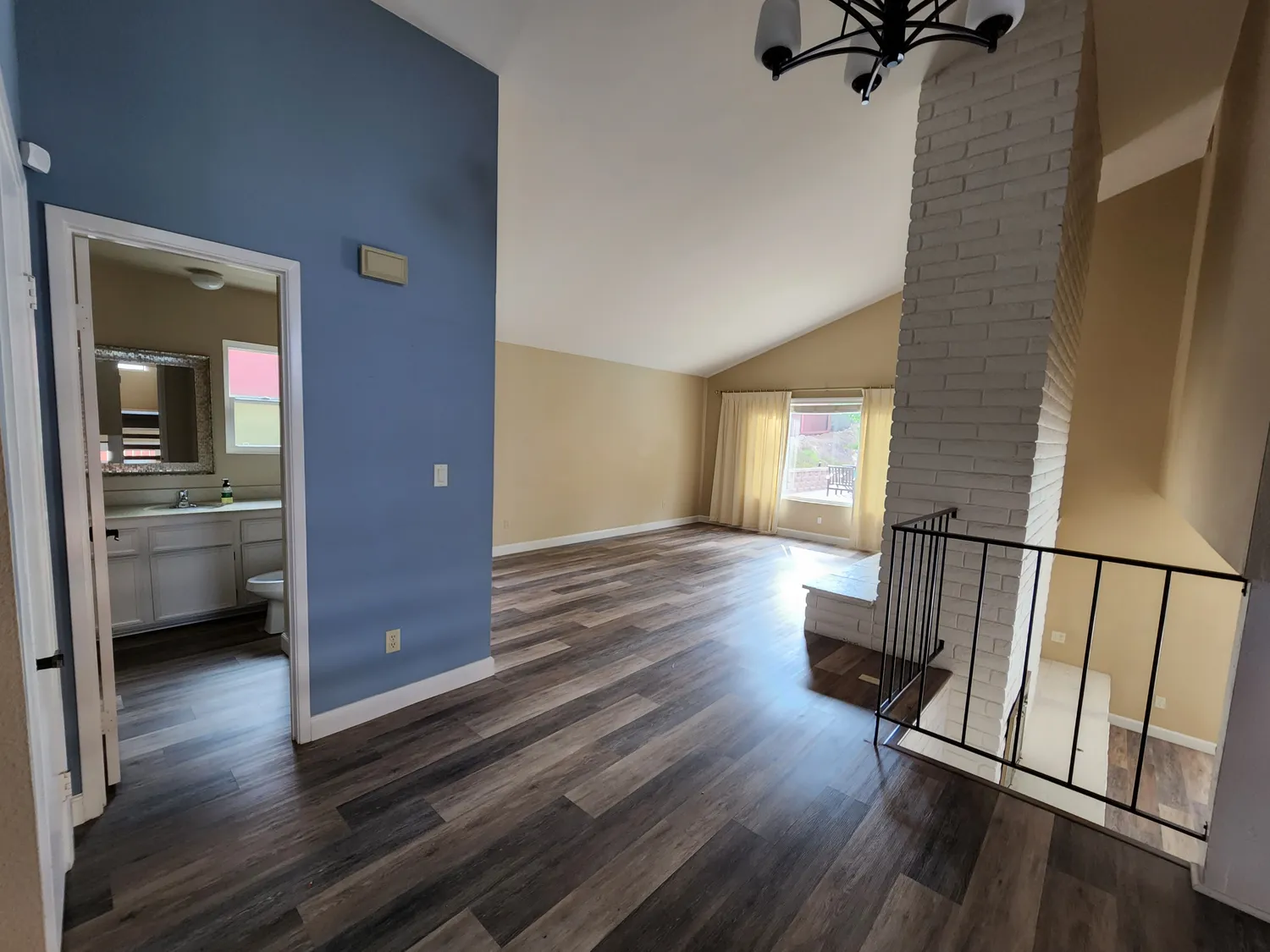 Empty, boxed-in living space with blue walls before the Scripps Ranch remodel